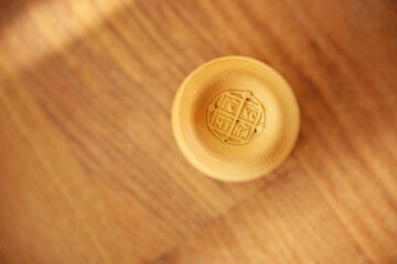 Prosphora on wooden background. Orthodox Christian church holy bread. Traditional sacred symbol.