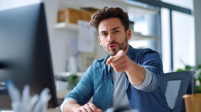 Business Frustration: A focused individual in an office setting, displaying visible signs of frustration, which is a relatable image for anyone familiar with modern workplace stressors.