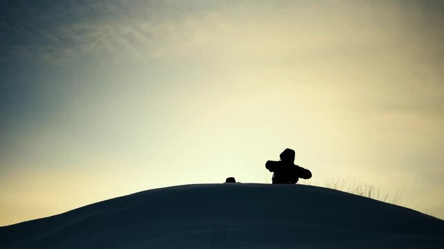 teamwork silhouette. handshake comrades rejoicing victory. shake hands command group mountain hill sunset. overcome difficulties. top cliff goal climbers. trekking snowy winter hike happy successful