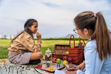 Mother and daughter celebrating mother's day with a countryside picnic
