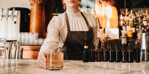 Bartender Serving Whiskey Cocktail on Marble Bar