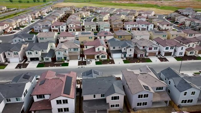 aerial view of a middle class brand new under construction residential houses neighborhood in a city suburbs. suburbia