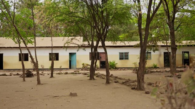 Empty school ground and buildings in village or town in Africa during summer. No kids or students. Break or vacation in Tanzania elementary school. Hot day outdoors in humble conditions