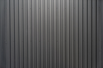 Black dark grey colored steel warehouse building exterior tiles close cup, steel pattern of exterior building