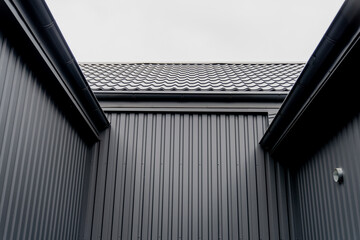 Dark steel tile warehouse roof in busy industrial area, dark steel roof and walls