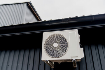 Minimalistic white fresh air conditioning fan unit outside the facade, for cold air creation and...