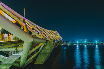 The Atal Bridge comes alive at night, its vibrant, colourful lights streaking across the water in a...