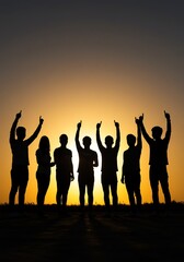 Fototapeta premium Group Silhouetted Against Sunset Pointing Upwards Together