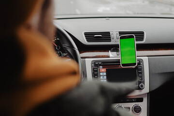 Man drive the car and using mobile app , green screen