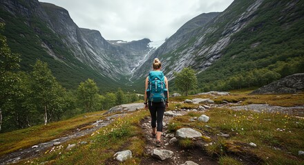 Fototapeta premium Woman Hiking on Mountain Trail with Backpack in Scenic Valley