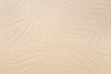 Textured beach sand as background, top view
