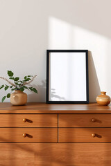 Obraz premium Minimalist black frame and white vase with flowers on dark wooden furniture, elegant interior decor.