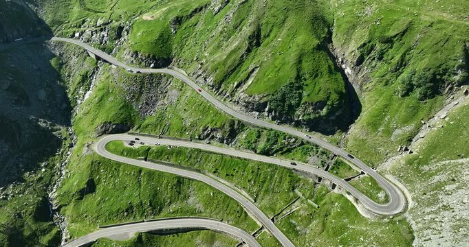 Reverse tracking aerial drone motion of the Transfagarasan Highway, mountain road on the Carpathian Mountains, one of the 10 most beautiful roads in the world, Romania, Eastern Europe