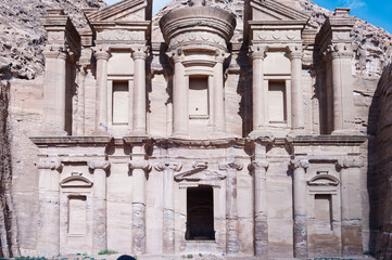 A large building with a lot of windows and a small door