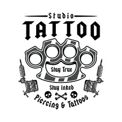 Vintage tattoo studio emblem with brass knuckles and tattoo machines. Classic monochrome vector illustration in retro style, perfect for badges, t-shirt prints and tattoo related designs