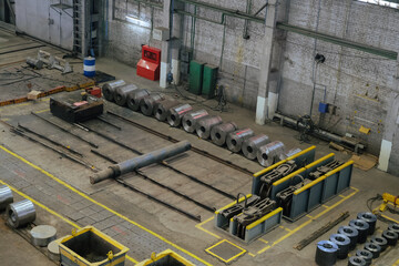 Metalworking factory production line. Rolls of steel sheets in workshop. Top view.