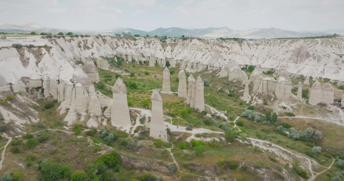 Aerial drone footage of Cappadocia's Love Valley, a unique landscape filled with extraordinary fairy chimneys and interesting rock formations.