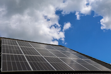 Photovoltaic panels providing clean energy on a roof under a cloudy sky