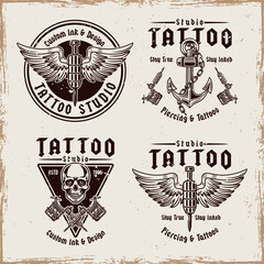 Vintage tattoo studio emblem set with classic elements like tattoo machines, anchors, skulls, and needles. Monochrome vector illustrations for labels, badges, prints, and branding