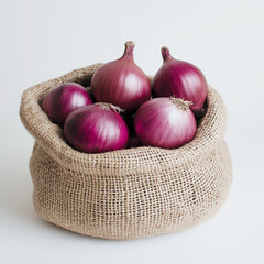 Fresh red onions in a jute bag placed on a white surface