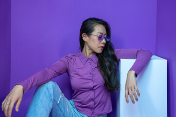 Cheerful lady with sunglasses pose isolated over violet background. High quality photo
