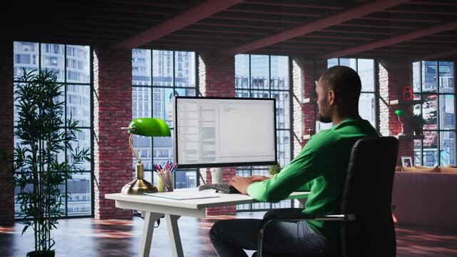 Black IT developer at PC coding and creating an app software, implementing algorithms to fix errors. Engineer in his loft working with code language, optimizing app performance. Camera A.