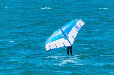 Windsurfer on the sea surface.