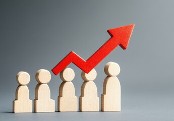 Growth of a team.  A group of wooden figures with a red upward arrow, suggesting increasing team size or performance