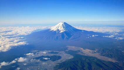 Fototapeta premium Majestic snow-capped peak, a symbol of Japan, seen from above, surrounded by clouds and the landscape below