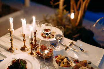 Elegant Dinner Table Setting with Candles and Gourmet Dishes