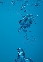 Many water bubbles on blue background, closeup