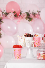 Candy bar. Many different sweets on table in festive decorated room