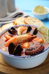 Delicious seafood soup in bowl on table, closeup