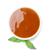 Tasty curry sauce in bowl and basil isolated on white, top view