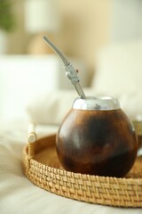 Traditional yerba mate tea on bed indoors, closeup