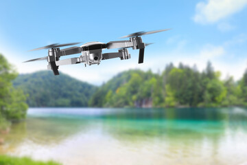 Drone with camera flying over bay. Unmanned aerial vehicle for surveillance