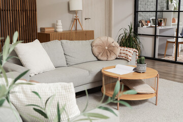 Interior of studio apartment with sofas, table and folding screen