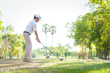 An Asian amateur golfer is enjoy playing golf in golf country club.
