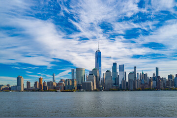 Fototapeta premium New York City skyline. NYC skyscrapers. Manhattan skyline. NY cityscape with clouds. Downtown New York buildings. NYC skyline, sky clouds. New York harbor view. Skyscrapers in Manhattan. NYC downtown.