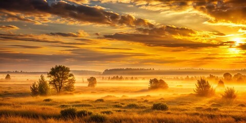 Obraz premium Misty Sunset Plains: Golden Light, Vibrant Sky, Serene Landscape Stock Photo