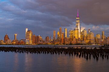 New York City at sunset. NYC cityscape with skyscrapers. Panoramic of New York City skyline. Manhattan skyline. New York and Hudson River. Downtown NYC. New York skyscrapers.