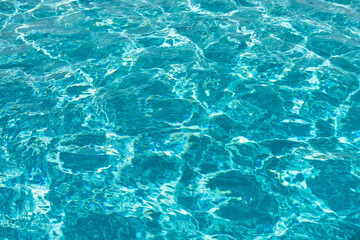 Ripped water in swimming pool. Surface of blue swimming pool, background of water.