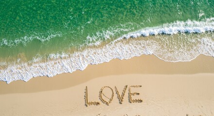Fototapeta premium Aerial view of waves washing over the word LOVE written in the sand on a beach, creating a romantic vacation scene and tranquil summer vibe