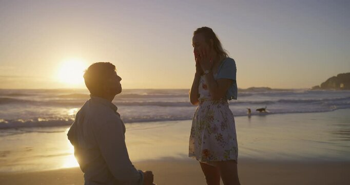Surprise, sunset or couple at beach for proposal for romance, love or commitment offer. Engagement, holiday vacation or man on knee to ask shocked woman question on valentines day or anniversary date