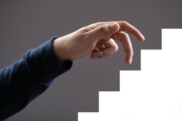 A hand reaching out towards a series of steps, symbolizing progress and aspiration. Perfect for...