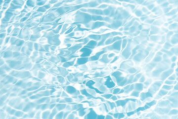 Blue water with ripples on the surface. Defocus blurred transparent blue colored clear calm water surface texture with splashes and bubbles. Water waves with shining pattern texture background.