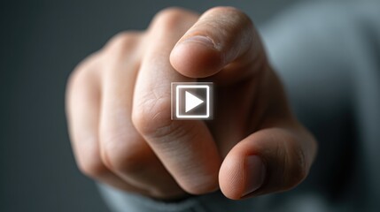 Hand pointing towards video player highlighting clear call-to-action button icon concept for user engagement