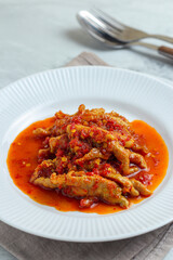 Dakbal. or Korean spicy chicken feet. Served on white plate.