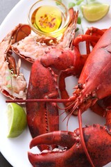 Delicious boiled lobster served on grey table, closeup