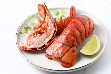 Delicious tails of boiled lobsters served on white table, closeup